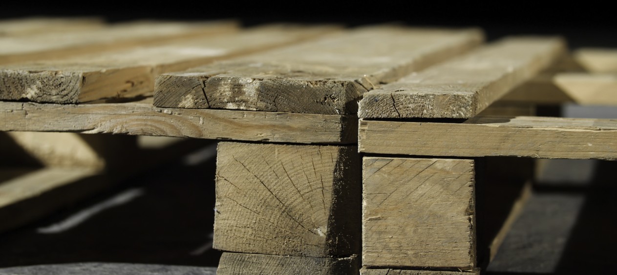 Close-up of wooden pallet. Angle of wooden pallet on grey concrete floor. Production of furniture using pallets